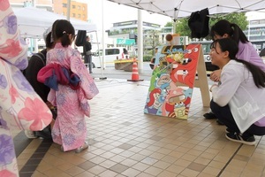 [写真]ござっせ横丁でミニゲームを楽しむ子ども