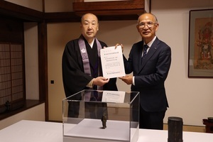 [写真]市有形文化財の認定書を手にする教育長と長福寺住職